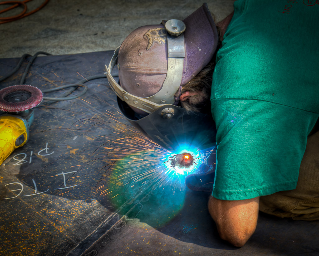 Scott Walcott welds two panels together while assembling Cynthia's vision