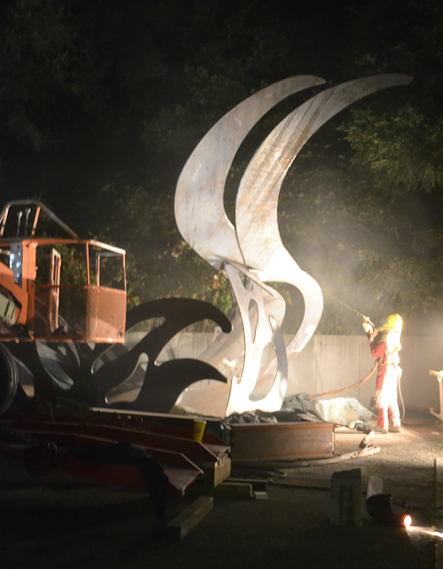 John Laurence painting the sculpture at night